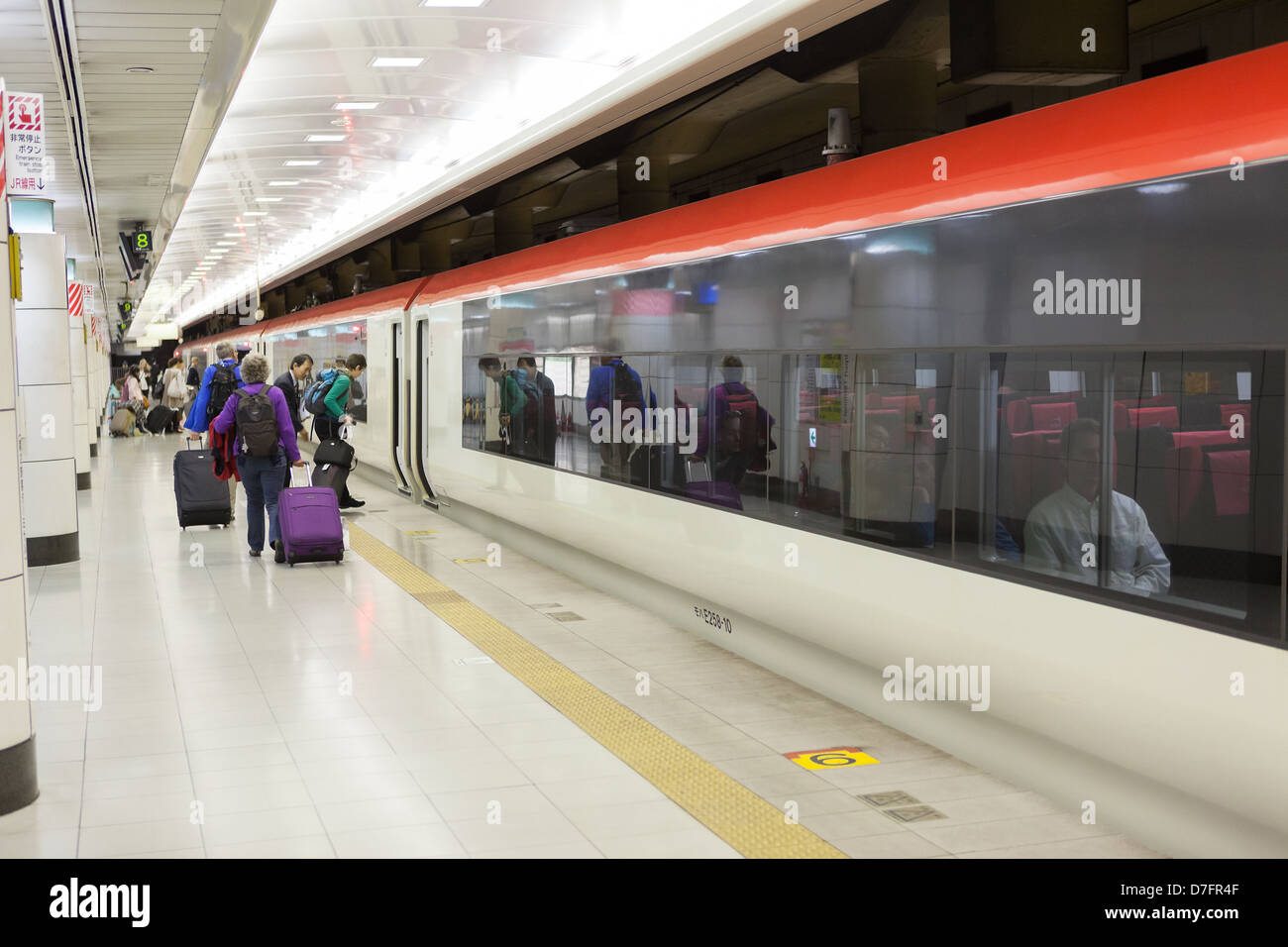 Passengers board a high-speed train N `EX (Narita Express) at Narita Airport to Tokyo station, Japan Stock Photo